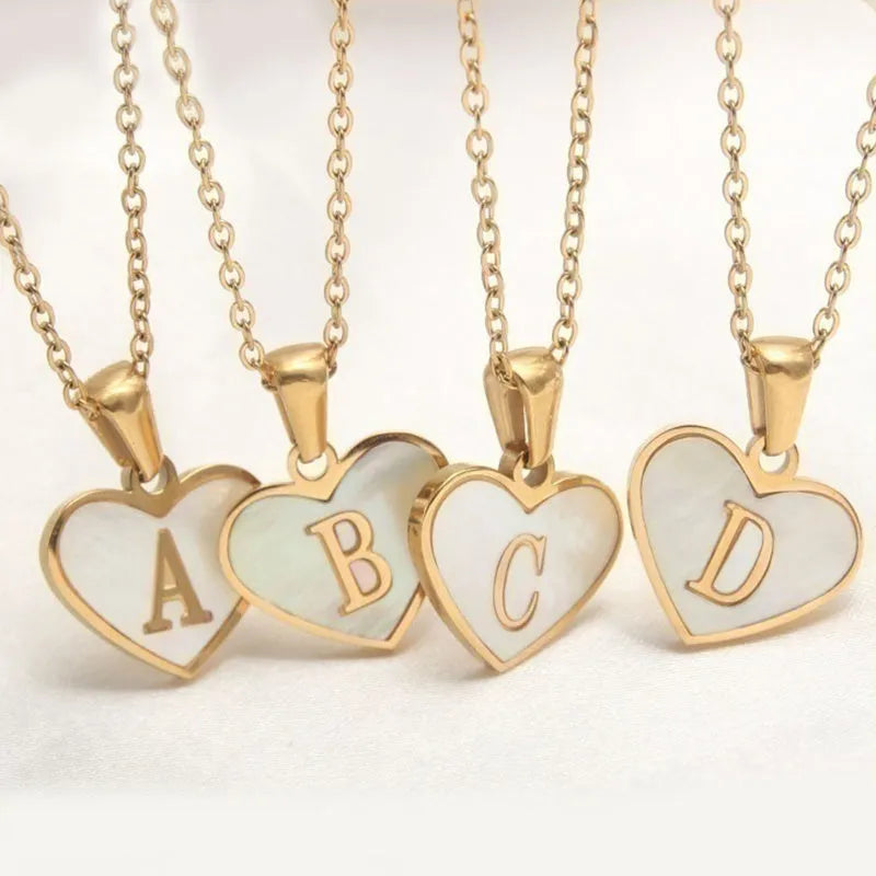 Heart-shaped letter necklace with white shell detail on gold-plated stainless steel chain