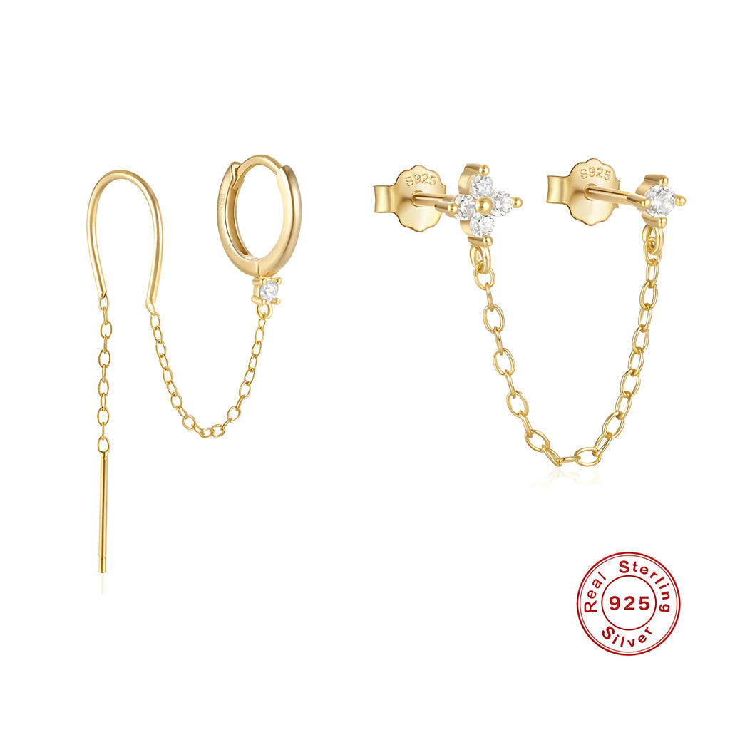 Close-up of a sterling silver stud earring with a geometric flower shape and dangling gold-tone tassel and chain details.