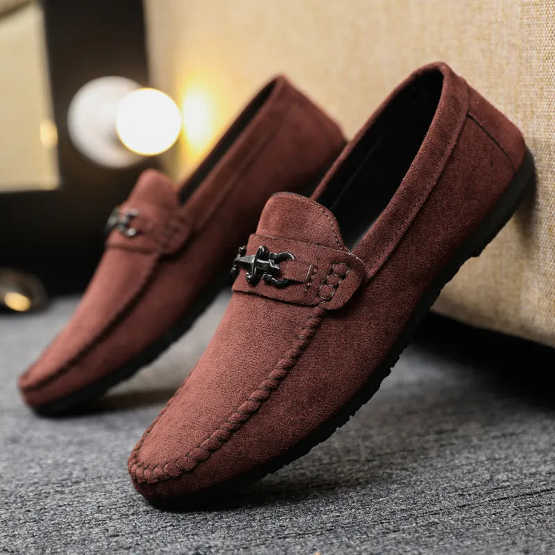 Men's black and brown waterproof slip-on loafers with round toe and low heel on a white background.