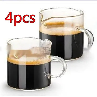 White transparent double-mouthed glass coffee cups showing two drinking openings