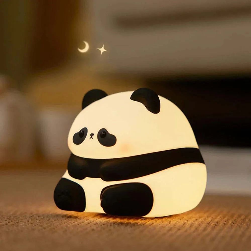 Cartoon panda-shaped night light with soft white glow on dark surface