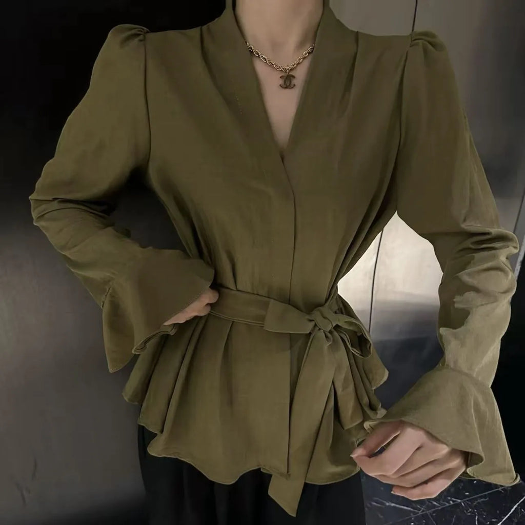 Women's black French-style shirt with an irregular collar, long flared bell sleeves, and a tied front closure.