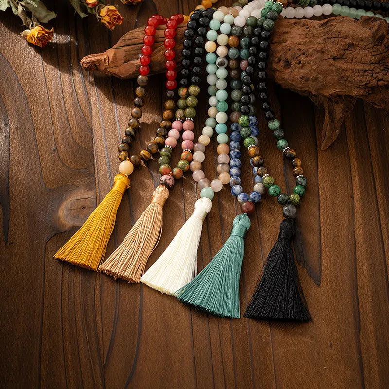 Bohemian style long bead necklace with tassel and matching bracelet on dark background