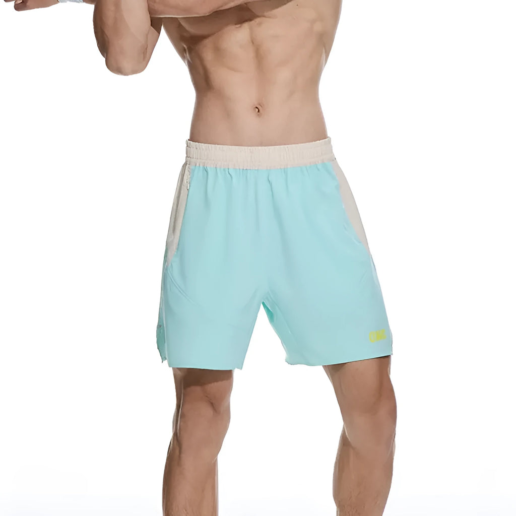 Man's loose grey workout shorts with elastic lace-up waistband, shown from side for gym use.