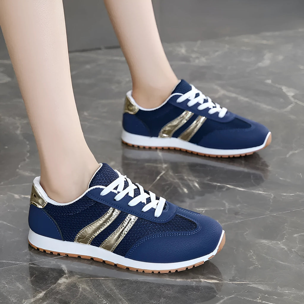 Blue women's casual tennis shoes with a cross strap and white non-slip rubber sole.