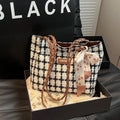 Black wool shoulder bag with horizontal square shape showing interior file compartment and phone pocket