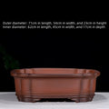 Large oval antique-finish purple clay flowerpot with carved crabapple tree design.