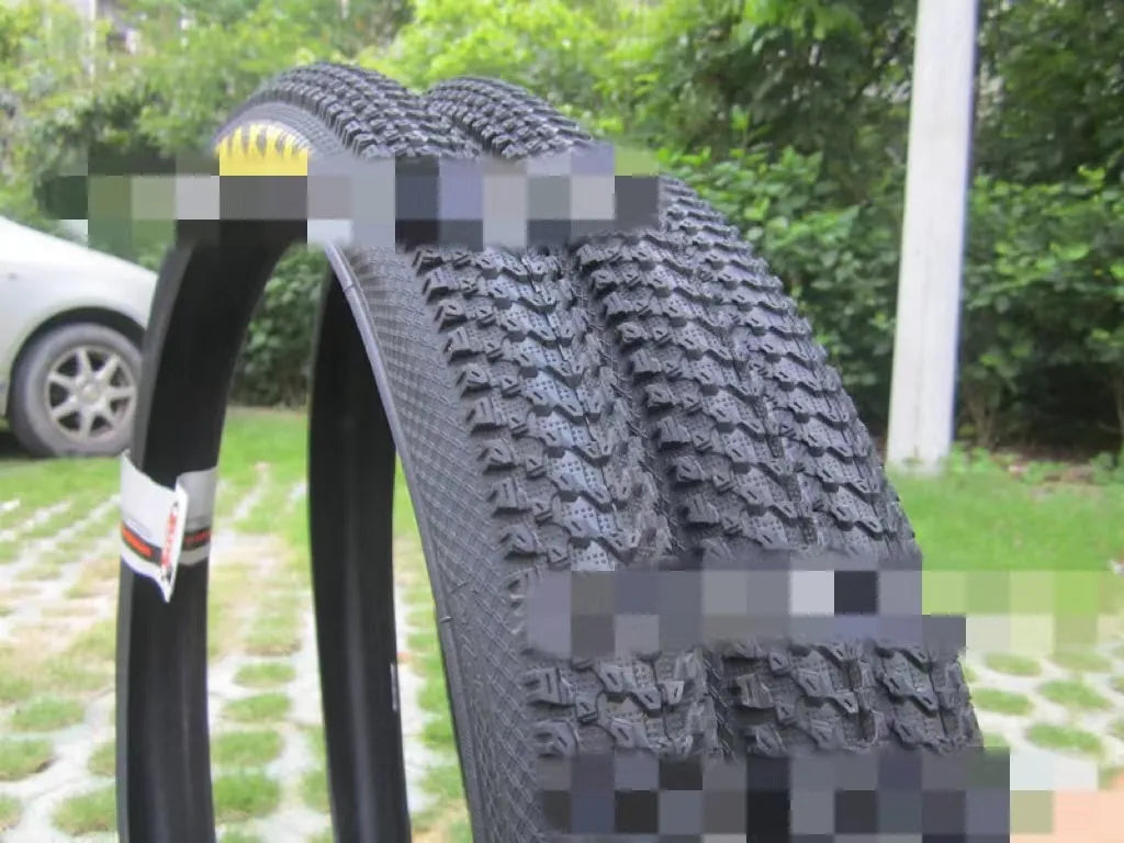 Ultralight puncture-proof mountain bike tyre showing tread pattern and available size options