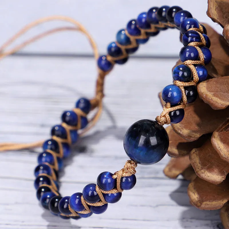 Close-up of a blue Tigereye hand-woven bracelet with a geometric pattern and pull closure.