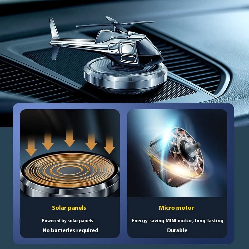 Metal solar helicopter car perfume ornament with rotating blades on a car dashboard.
