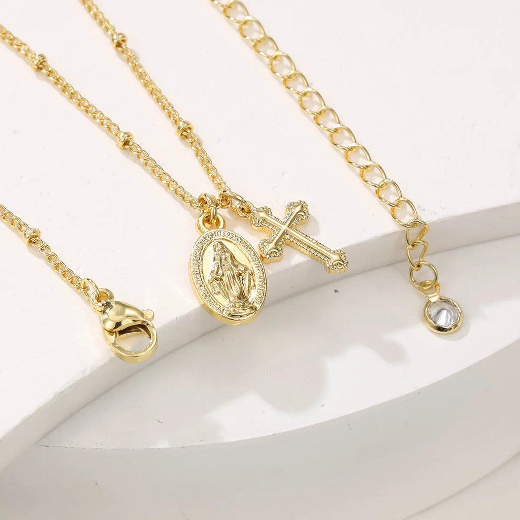 Gold Virgin Mary necklace with geometric cross pendant on copper with 18K plating