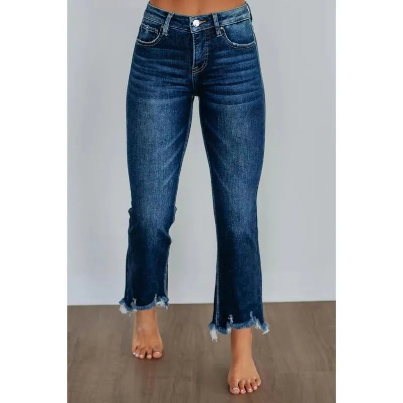 Solid colour women's cotton denim jeans with a hand-distressed finish in dark blue
