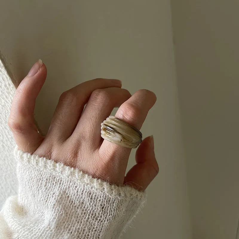 Chinese style geometric resin ring with irregular wide band design in neutral colour