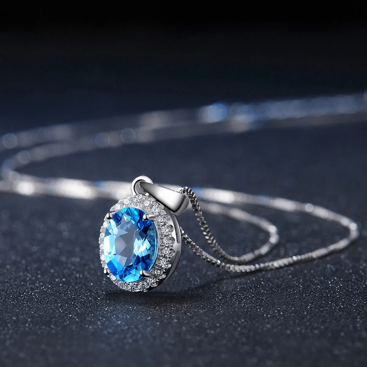 925 sterling silver geometric jewellery set with blue topaz gemstones including earrings, ring, pendant and necklace