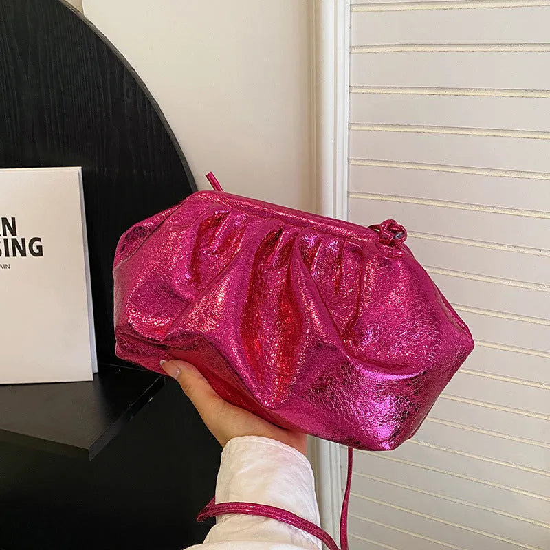 Simple shell-shaped PU leather crossbody bag in rose red with internal organiser pockets.