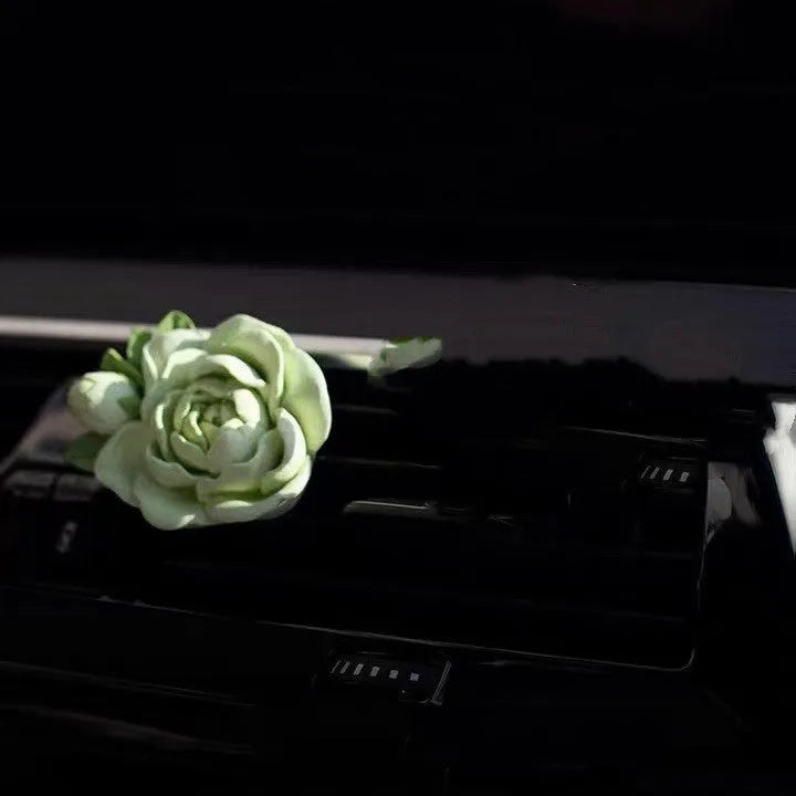 Jasmine car perfume solid air outlet freshener in off white or fresh green colour on car vent
