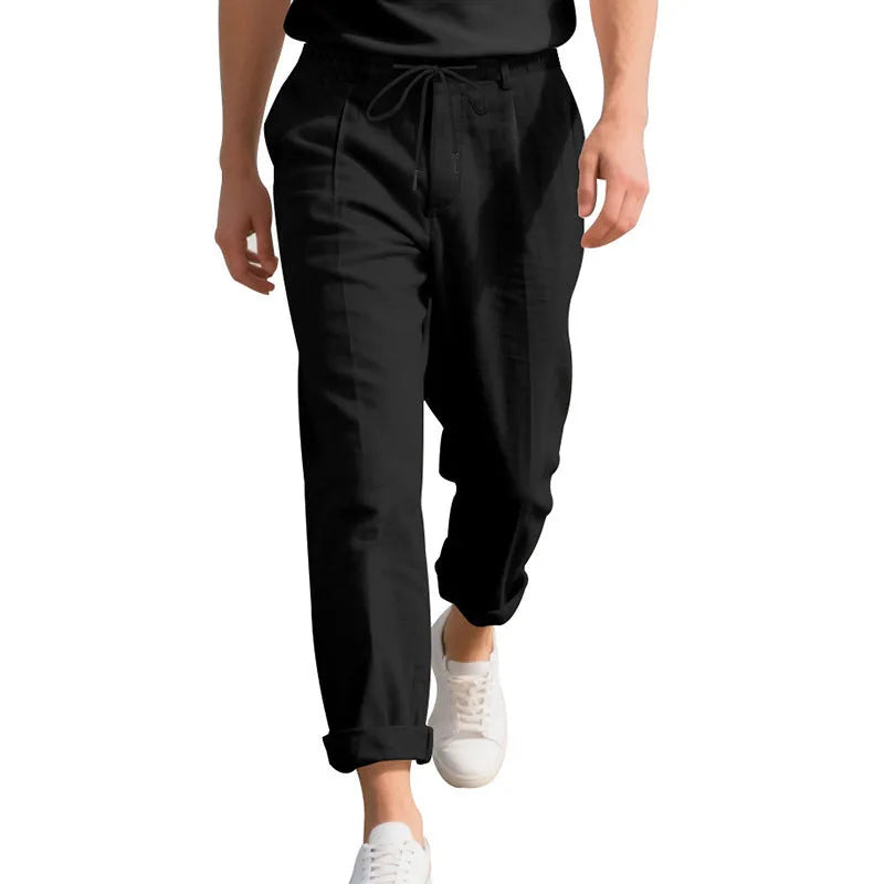 Men's light khaki linen casual trousers with a drawstring waist and straight leg fit.
