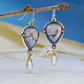 Retro blue drop earrings with synthetic blue opal and white pearl on electroplated metal.