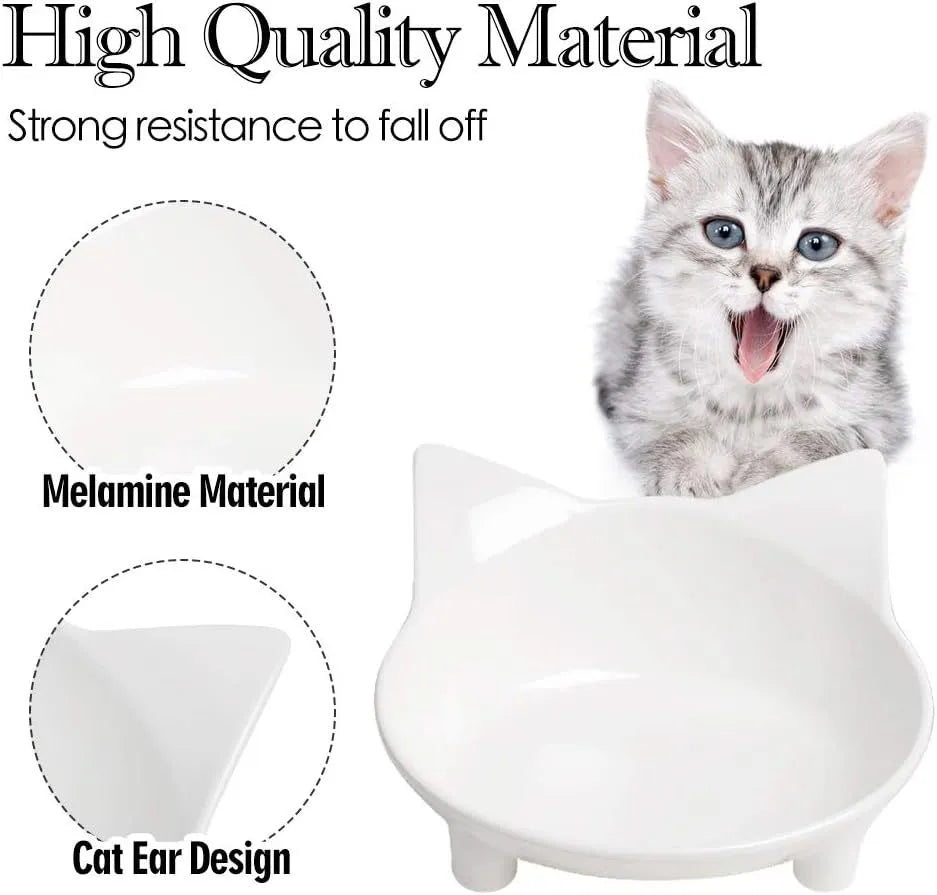 Four shallow black melamine pet bowls with non-slip rubber bases on a table.