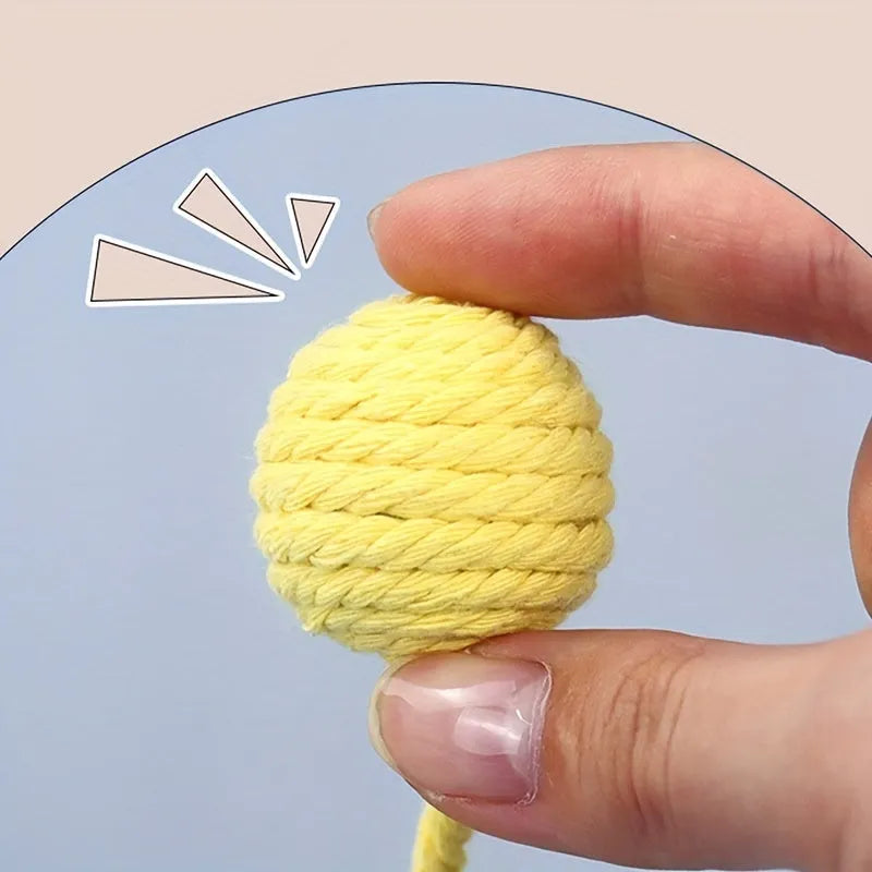 Colourful cat toy ball with attached rope and internal bell for interactive feline play
