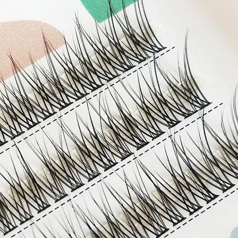 Black V-shaped fishtail false eyelashes on a white background showing graduated length design.