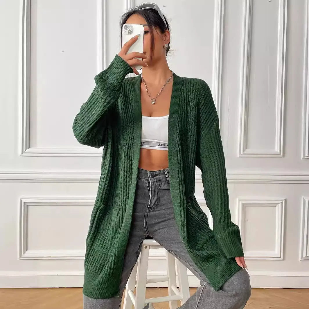 Women's dark green loose-fit mid-length acrylic cardigan sweater on a hanger.