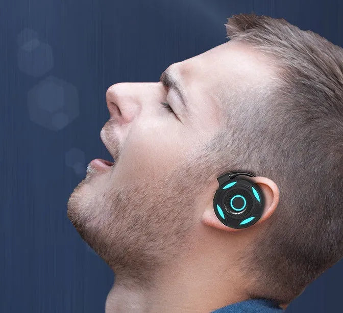 Black wireless Bluetooth earphones with hanging ear design showing USB charging port