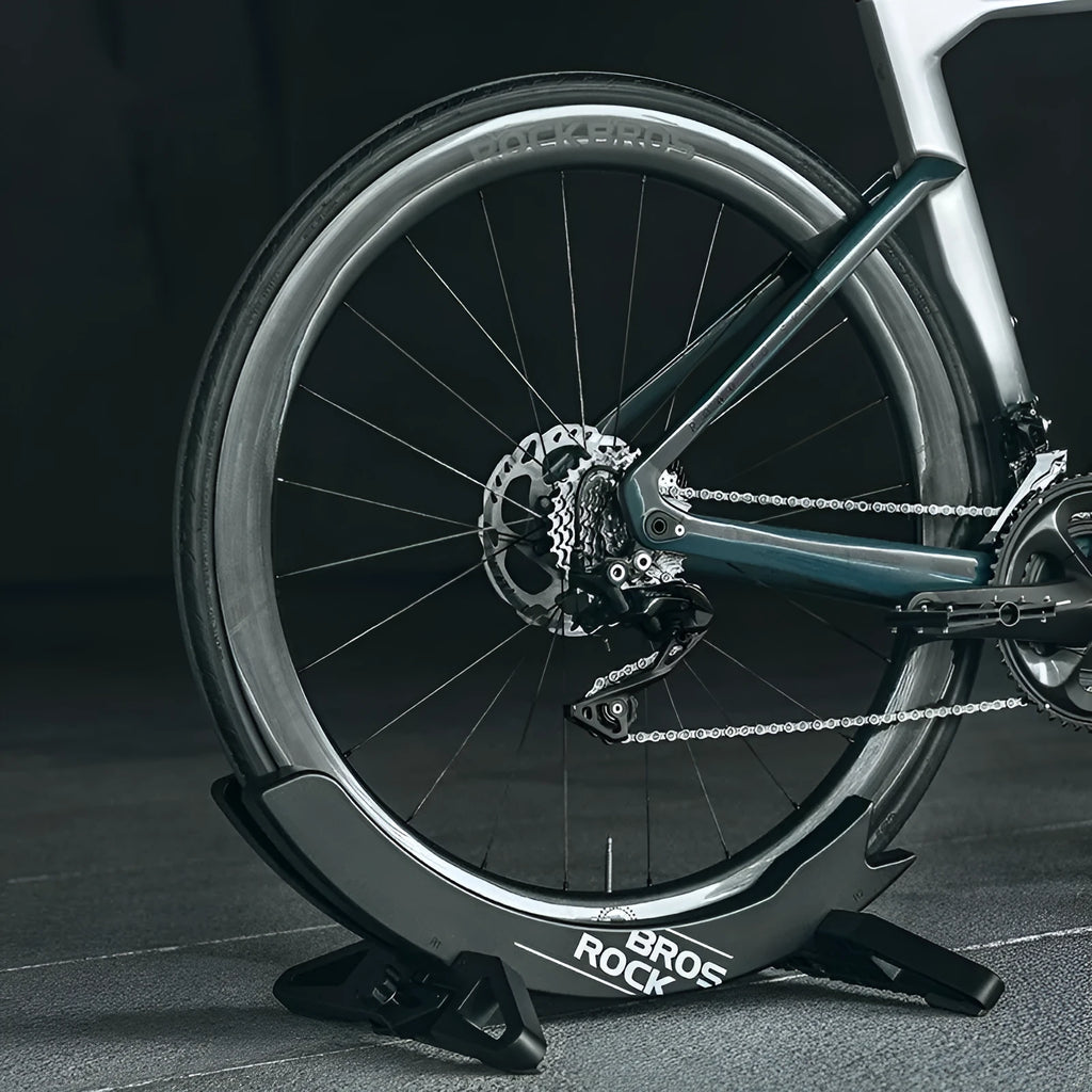 Black ABS plastic wall-mounted bike parking rack holder for road and mountain bicycles.