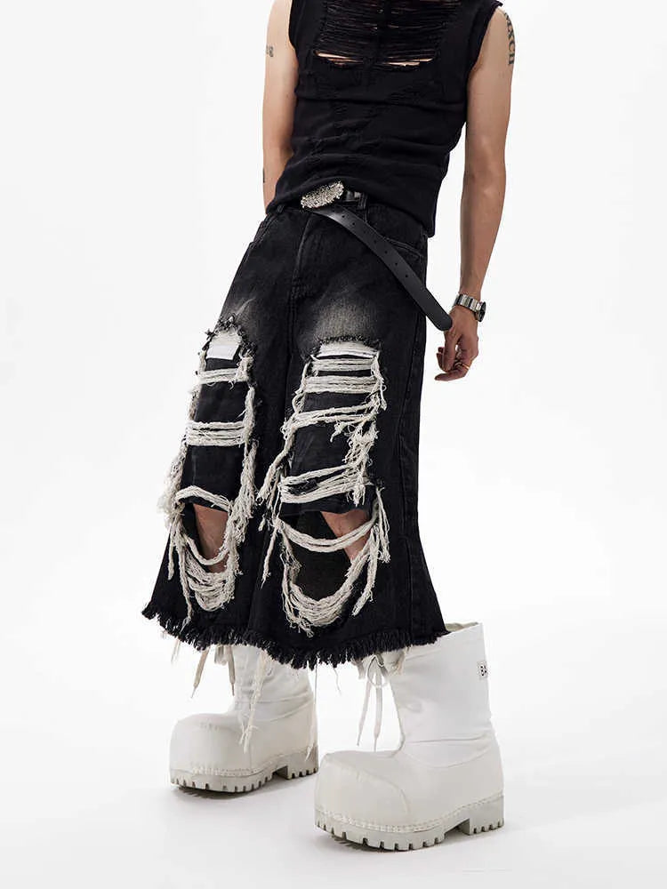 Black women's cropped wide leg jeans with ripped patch details and a mid-high waist.