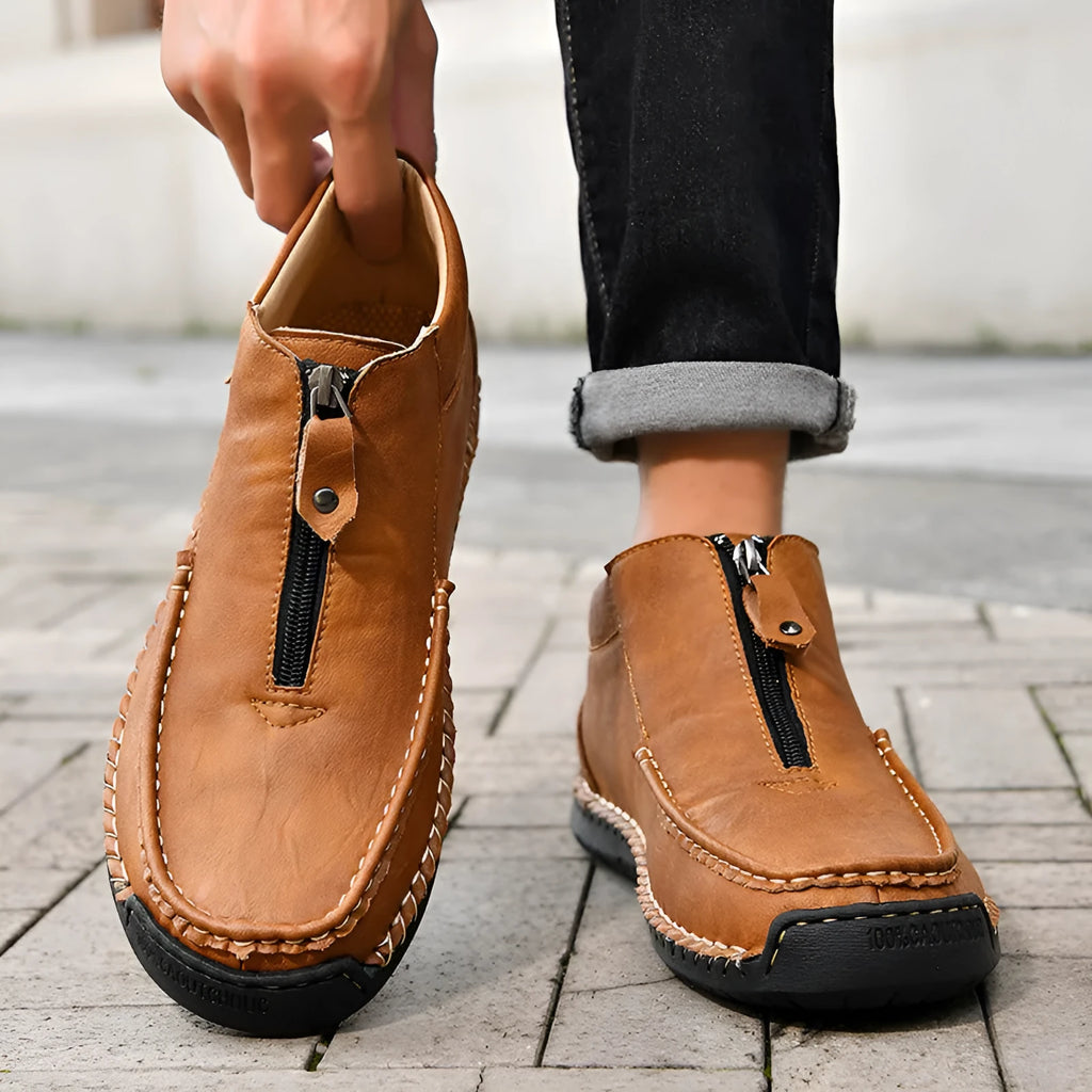 Men's black slip-on leather loafers with round toe and flat rubber sole