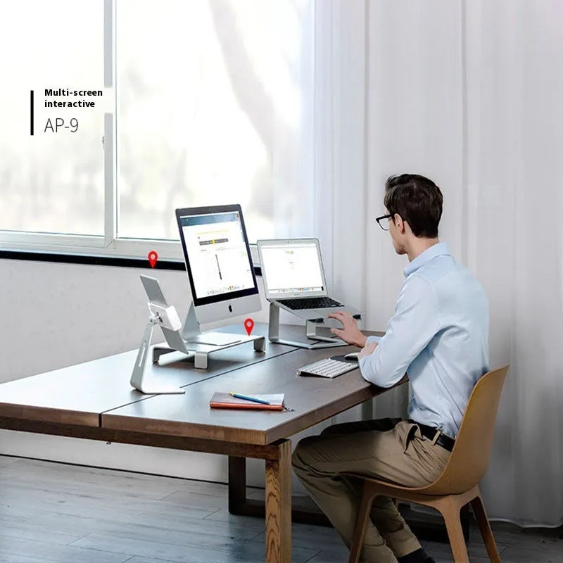 Black aluminium alloy laptop stand with ventilation slots on desktop