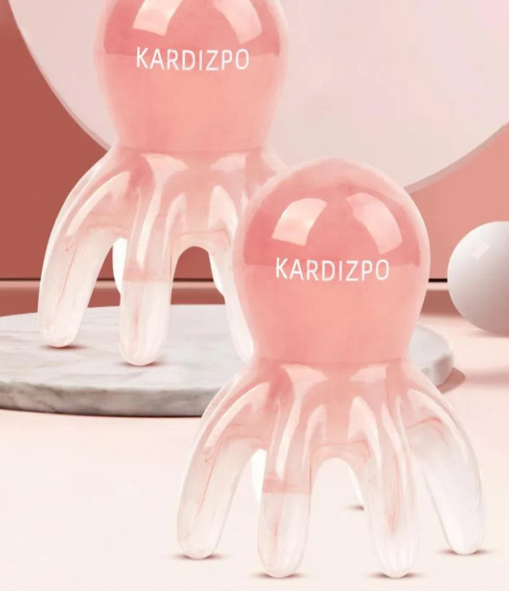 Small pink octopus-shaped natural resin massage comb with storage bag for facial meridian pressure.