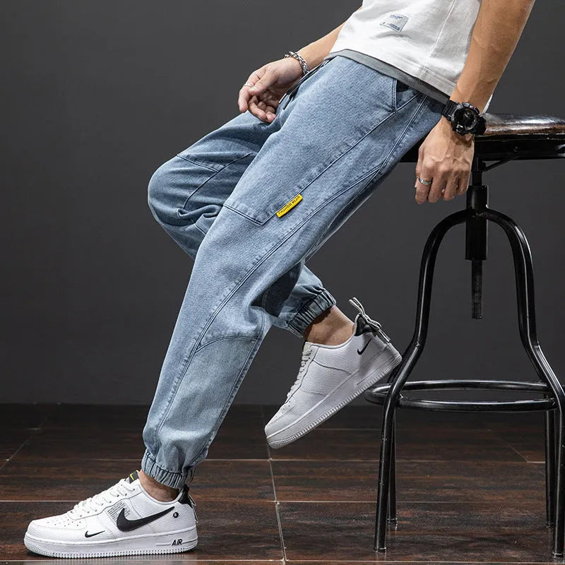 Men's loose fit cargo jeans in blue with straight leg and front pockets.