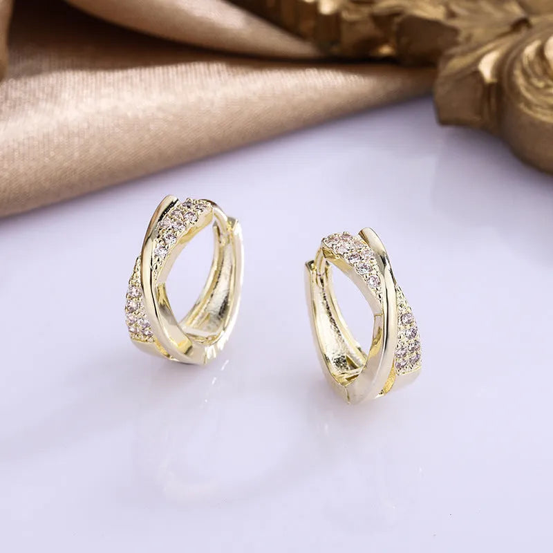 A pair of geometric drop earrings with zircon crystals in a 14K yellow finish.