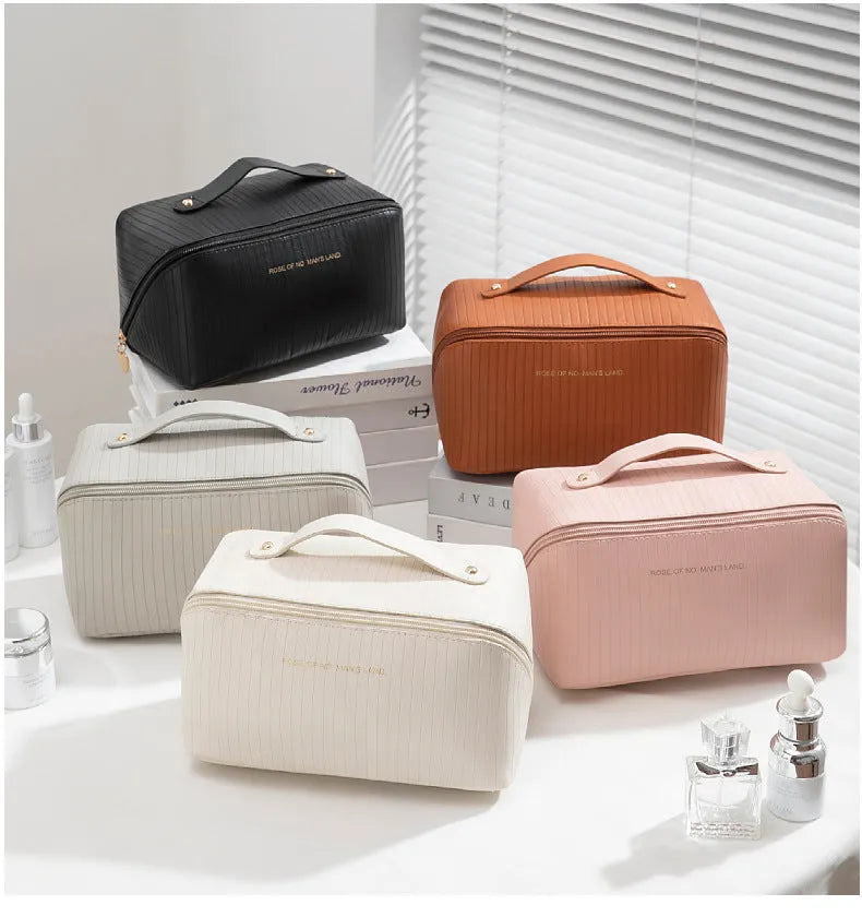 Vertical striped cubic makeup bag in beige with 22.5cm dimensions showing open interior