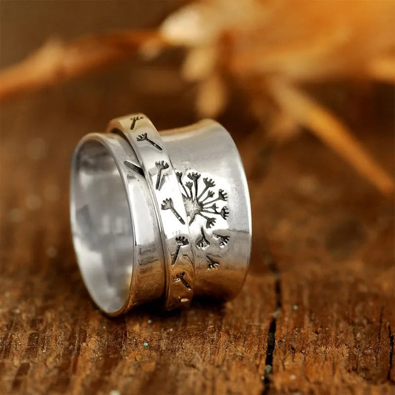 Silver rotatable flower ring showing floral detail and adjustable positioning
