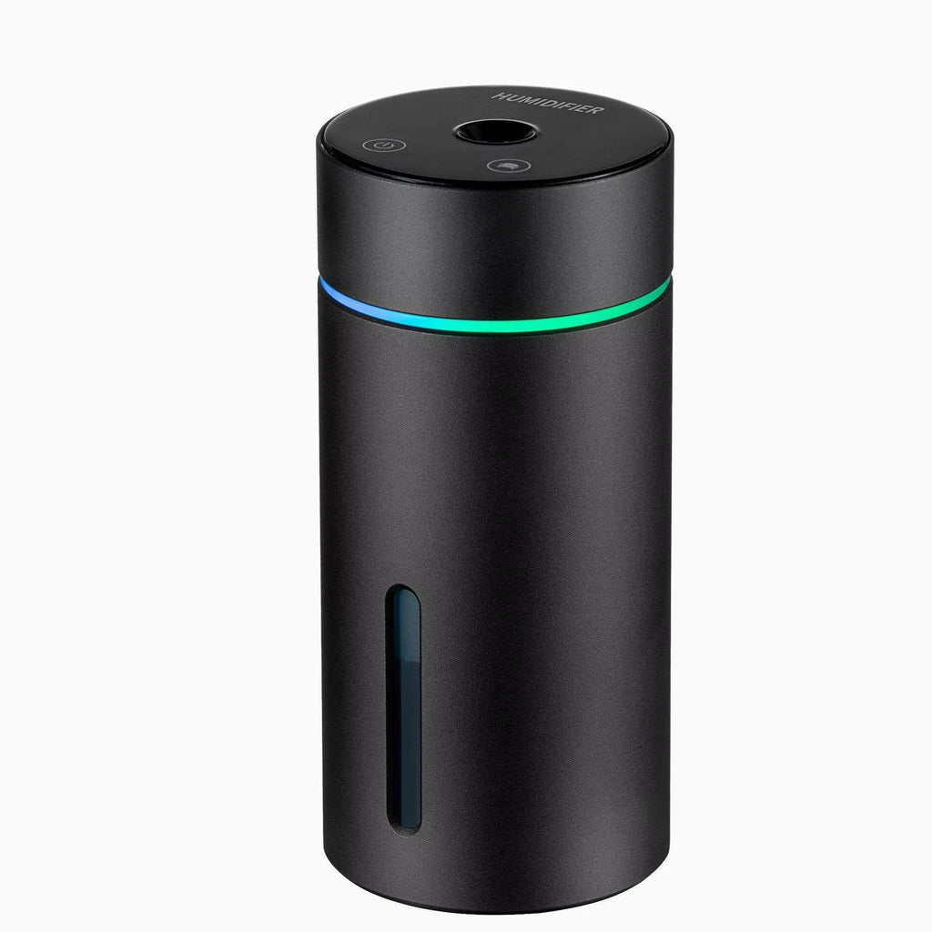 Compact black aluminium car humidifier and essential oil diffuser with USB cable on a desk.