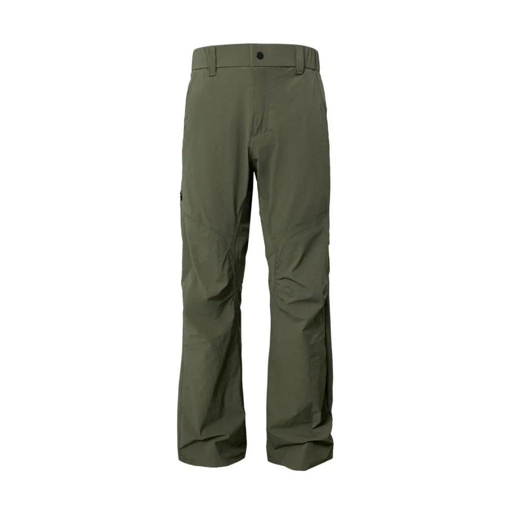 Man wearing grey 3D cut deconstructed casual trousers with a straight leg and elasticated waist.