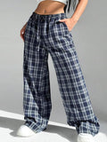 Blue loose fit women's plaid trousers with drawstring waist and pockets on a neutral background.