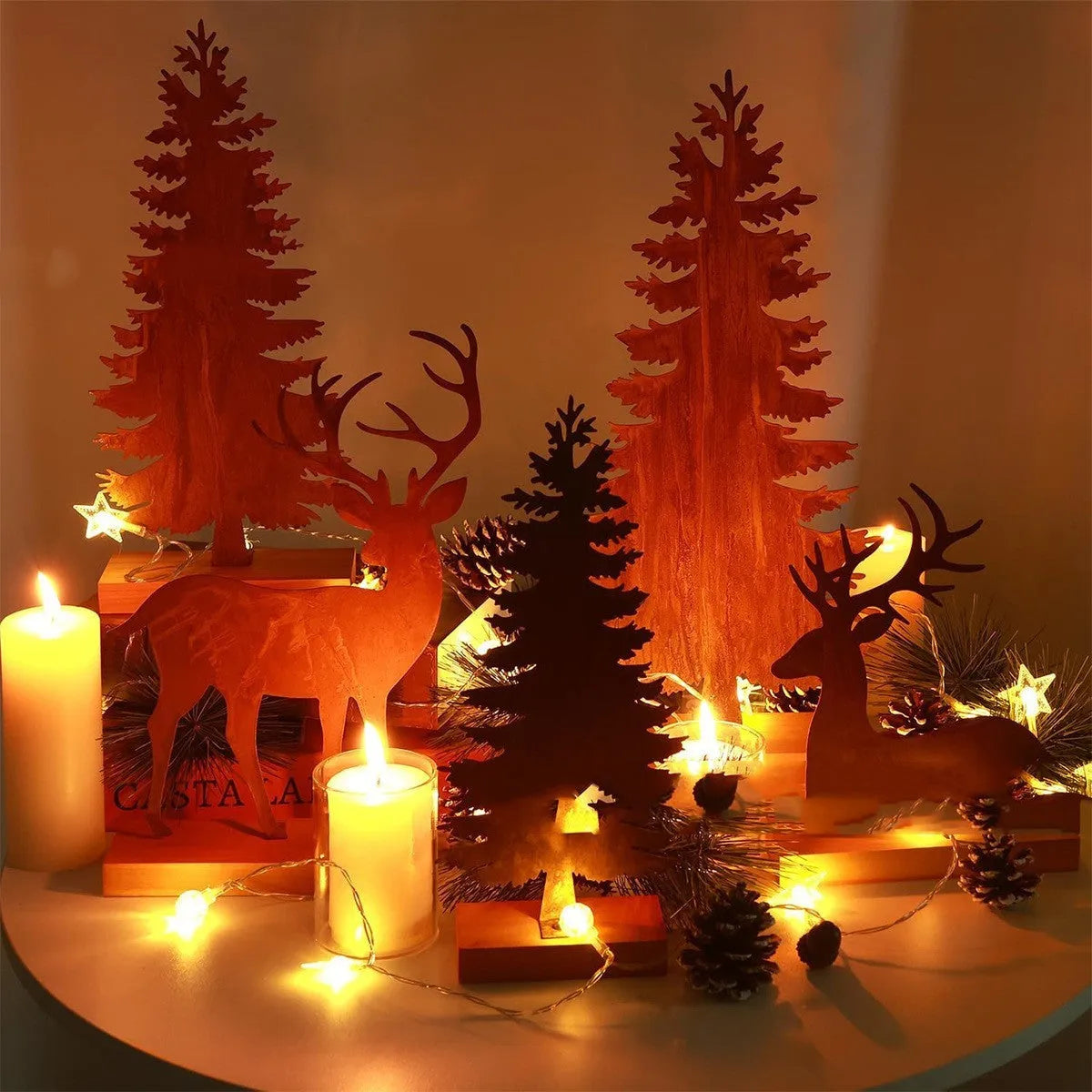 Set of three rustic metal Christmas ornaments featuring elk and tree silhouettes with an aged iron finish.