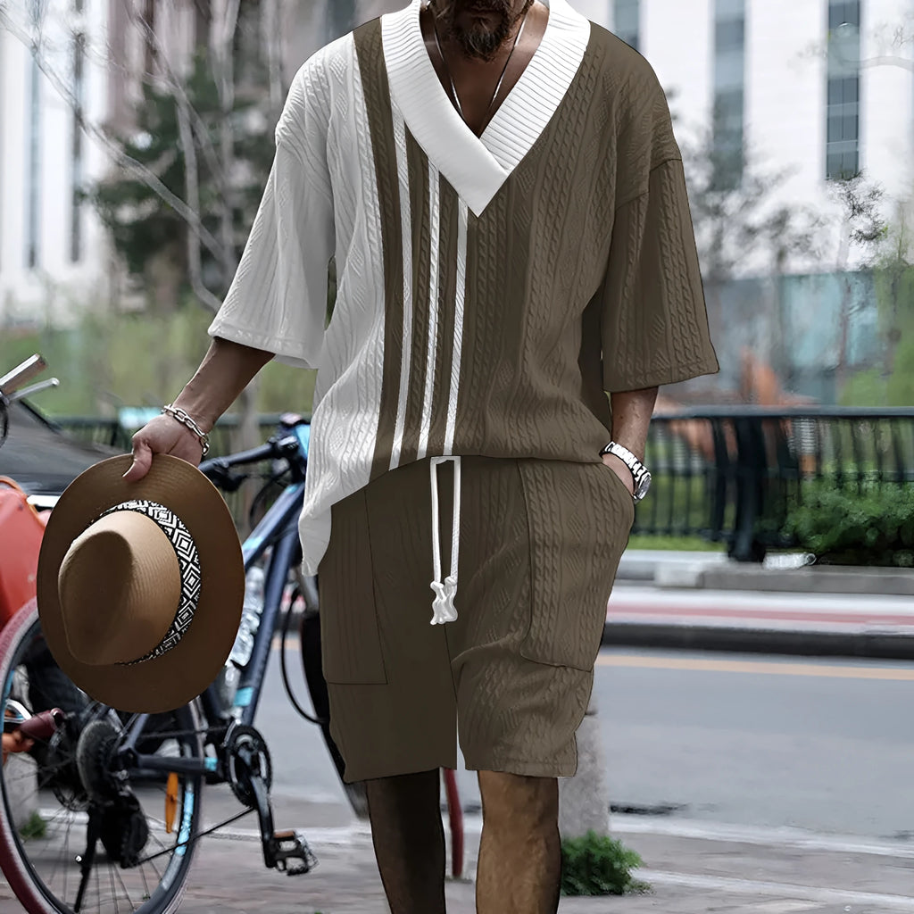 Man wearing a printed drop-shoulder knitted short-sleeve top with matching shorts in a casual setting.