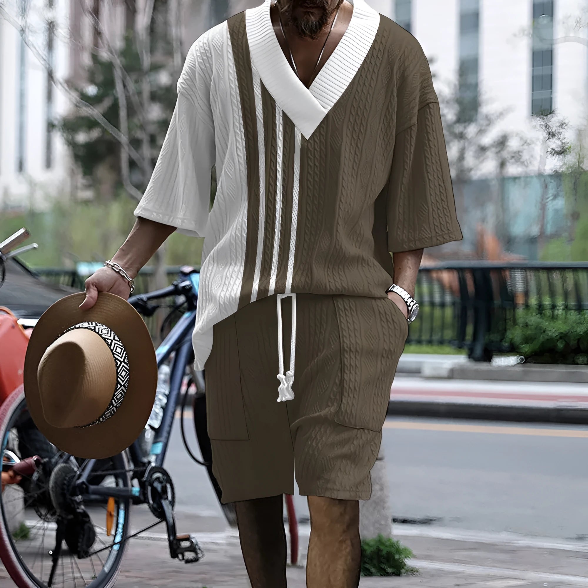 Man wearing a printed drop-shoulder knitted short-sleeve top with matching shorts in a casual setting.