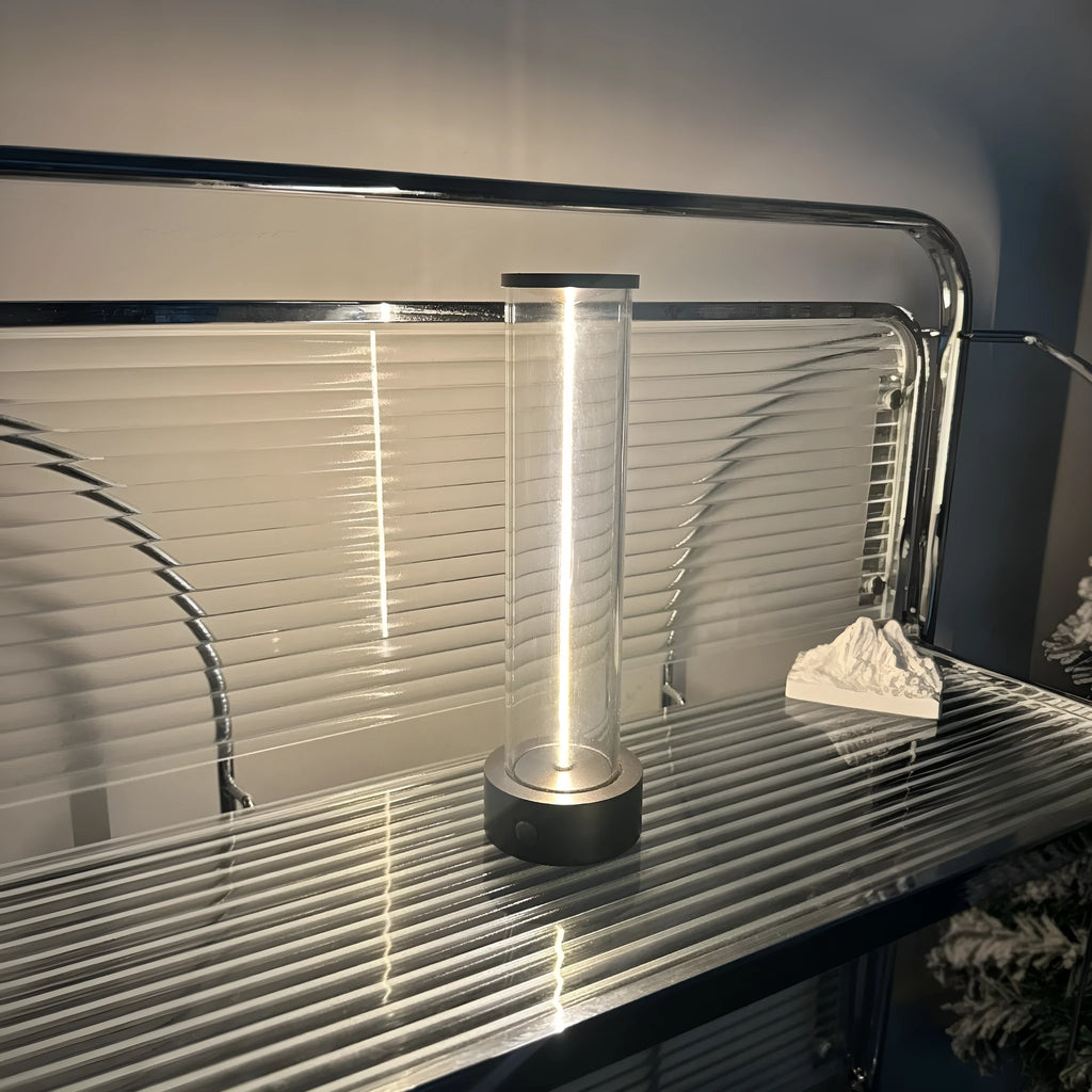 Modern glass LED light strip with magnetic back, measuring 234mm high, on a metal surface.