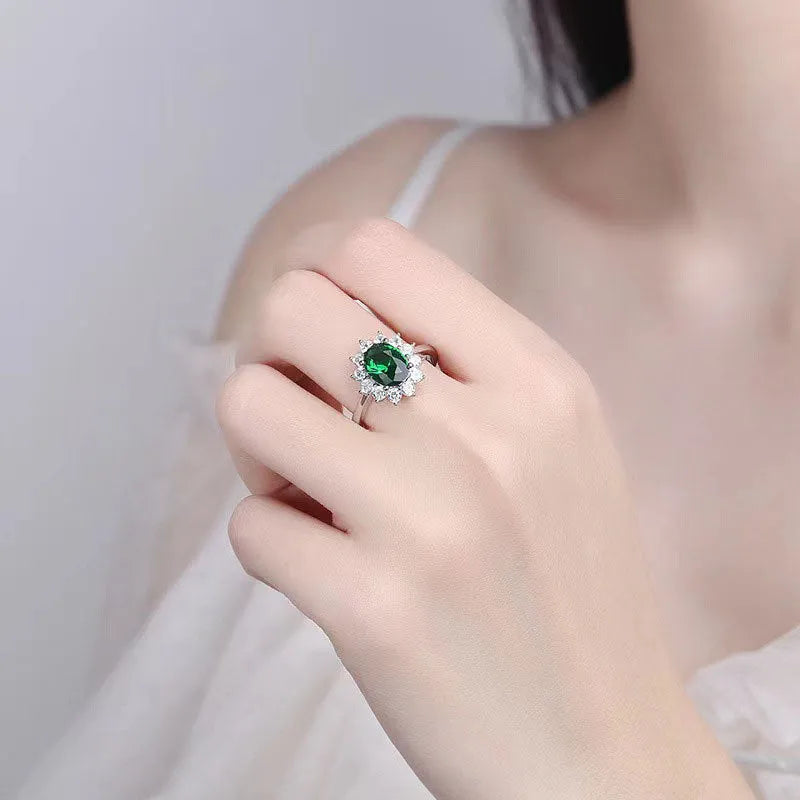 Electroplated copper flower-shaped ring with inlaid blue zirconium stone on a woman's finger.