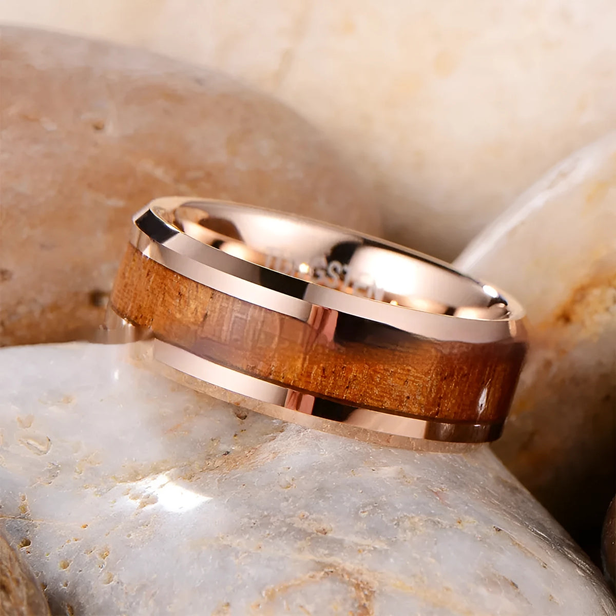 Men's tungsten ring with hair texture design in Ugyen, shown in rose gold and steel electroplated finishes.