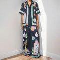Black women's casual set with cartoon animation print showing cardigan top and matching trousers