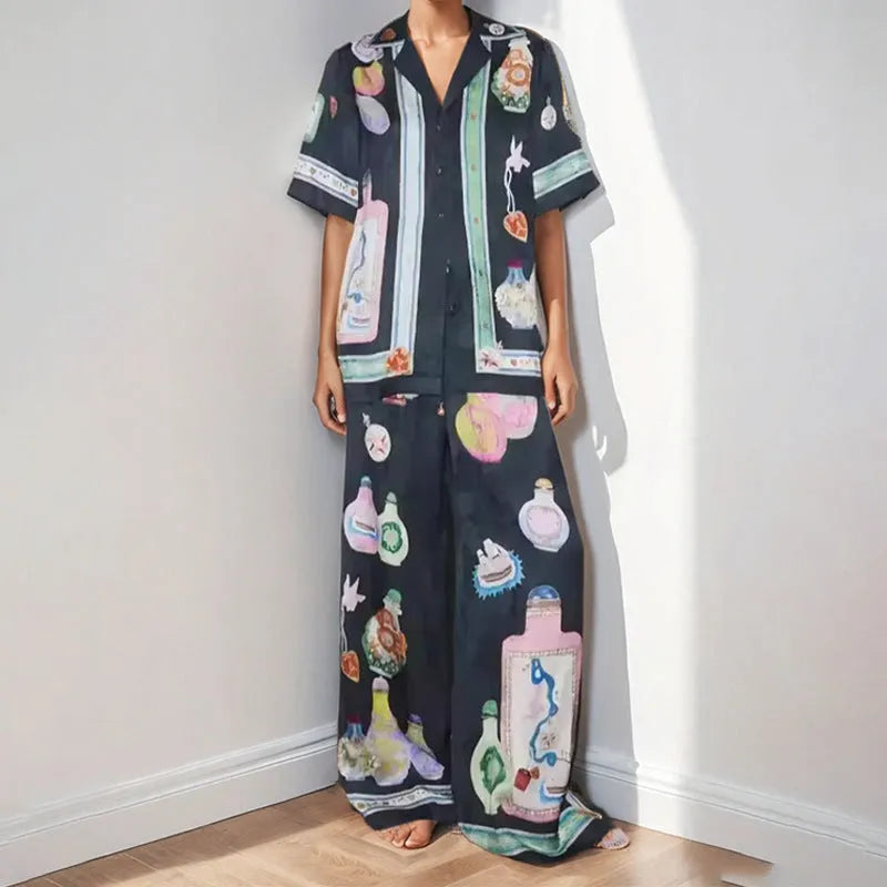 Black women's casual set with cartoon animation print showing cardigan top and matching trousers