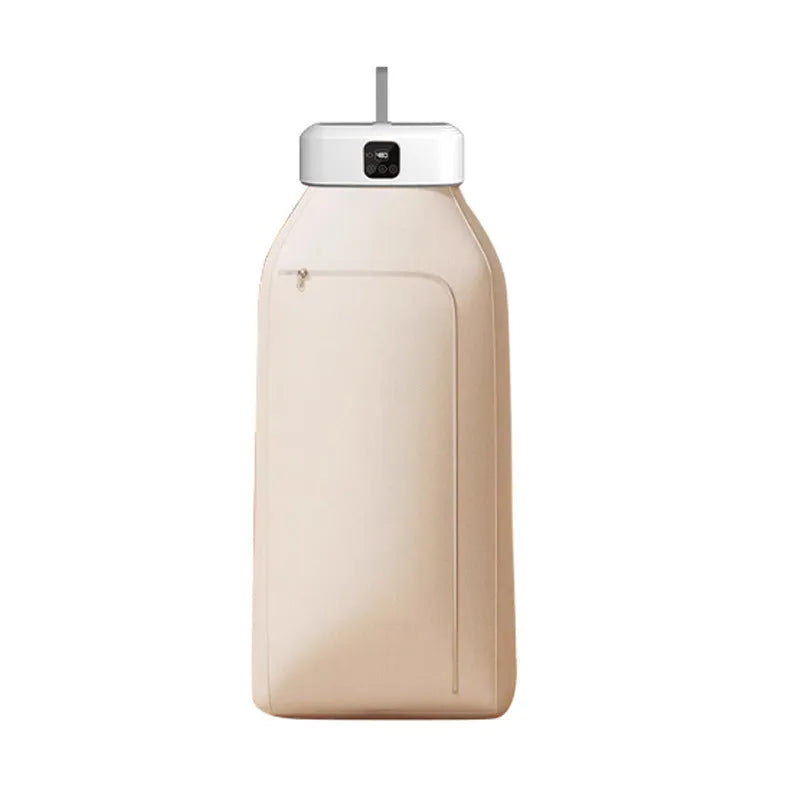White cylindrical portable mini clothes dryer with remote control on a table.