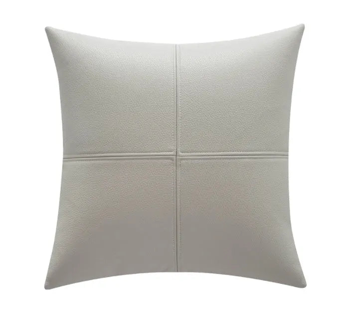Simple solid colour soft cowhide leather pillow cover on a grey sofa