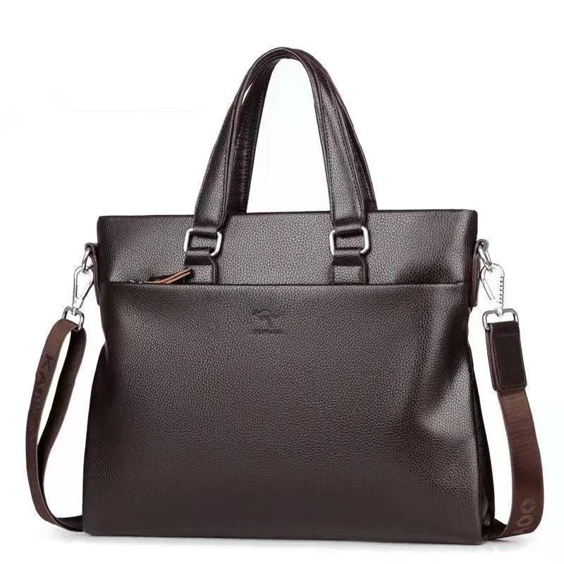 Men's black PU leather shoulder messenger bag with splicing design on a table.